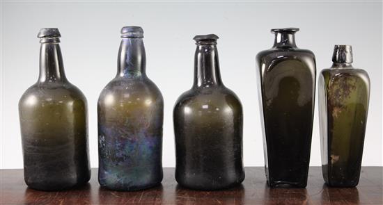 Five dark green glass bottles, late 18th / early 19th century, 22.5 - 23cm